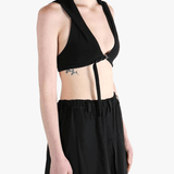 Black tops worn by a person, showing the tops fit