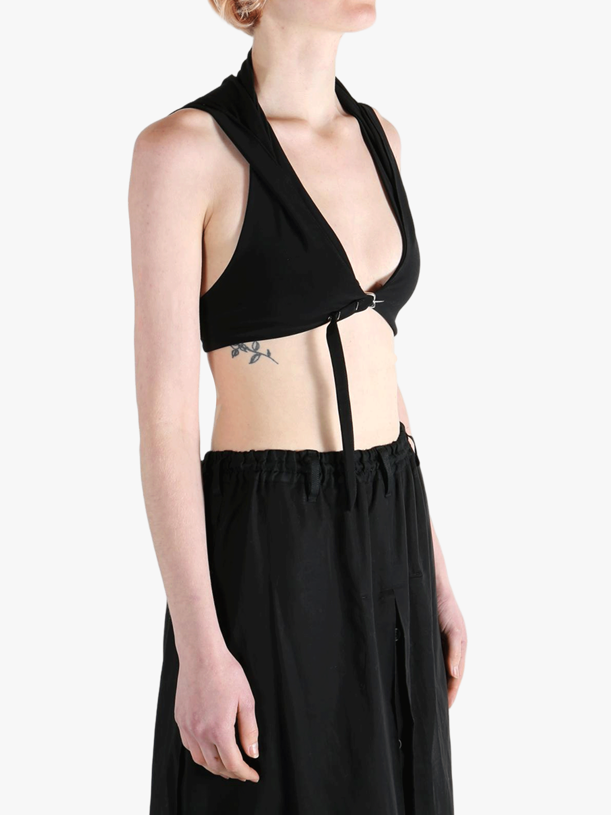 Black tops worn by a person, showing the tops fit