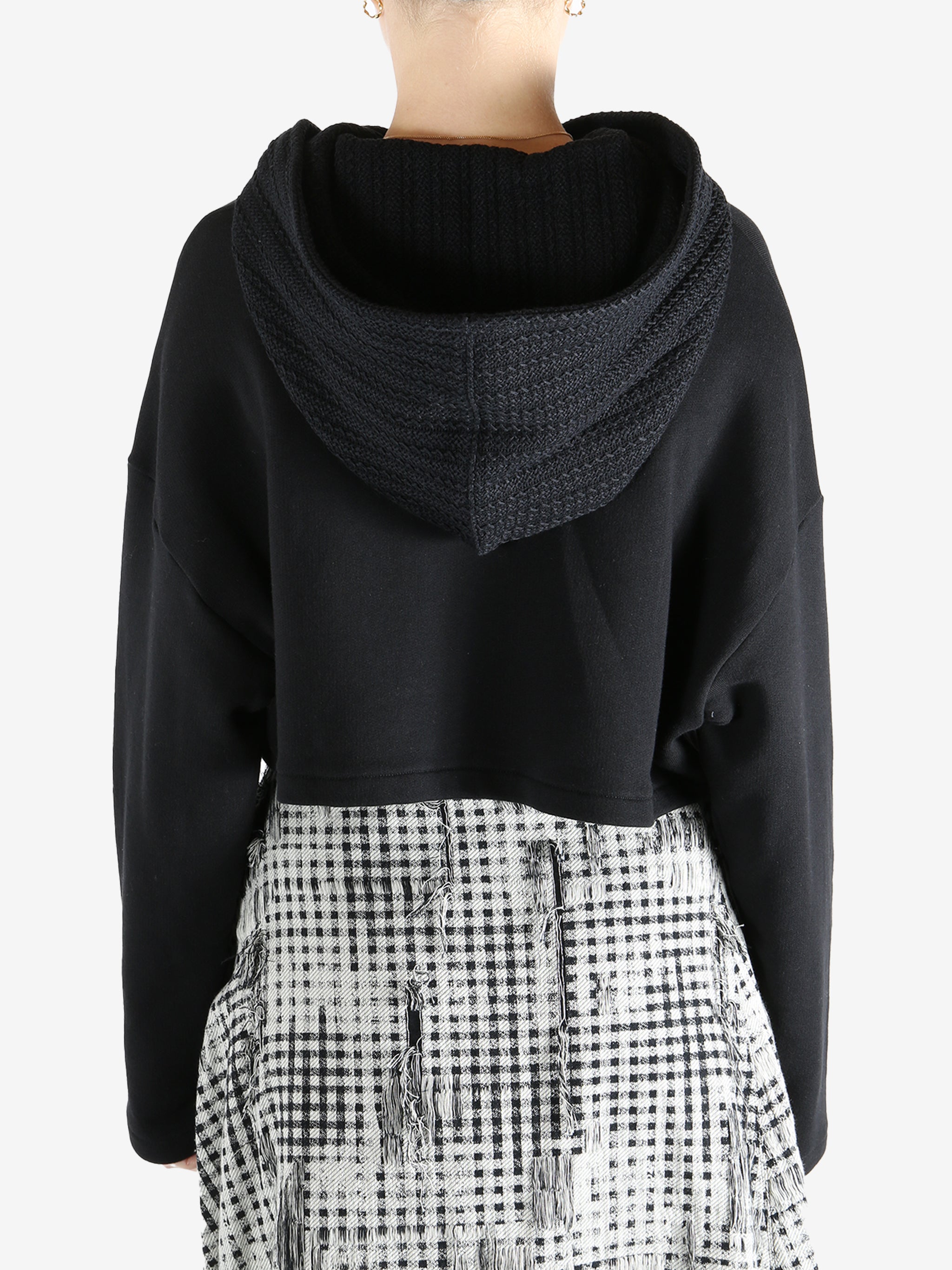 Black coats worn by a person, showing the coats fit