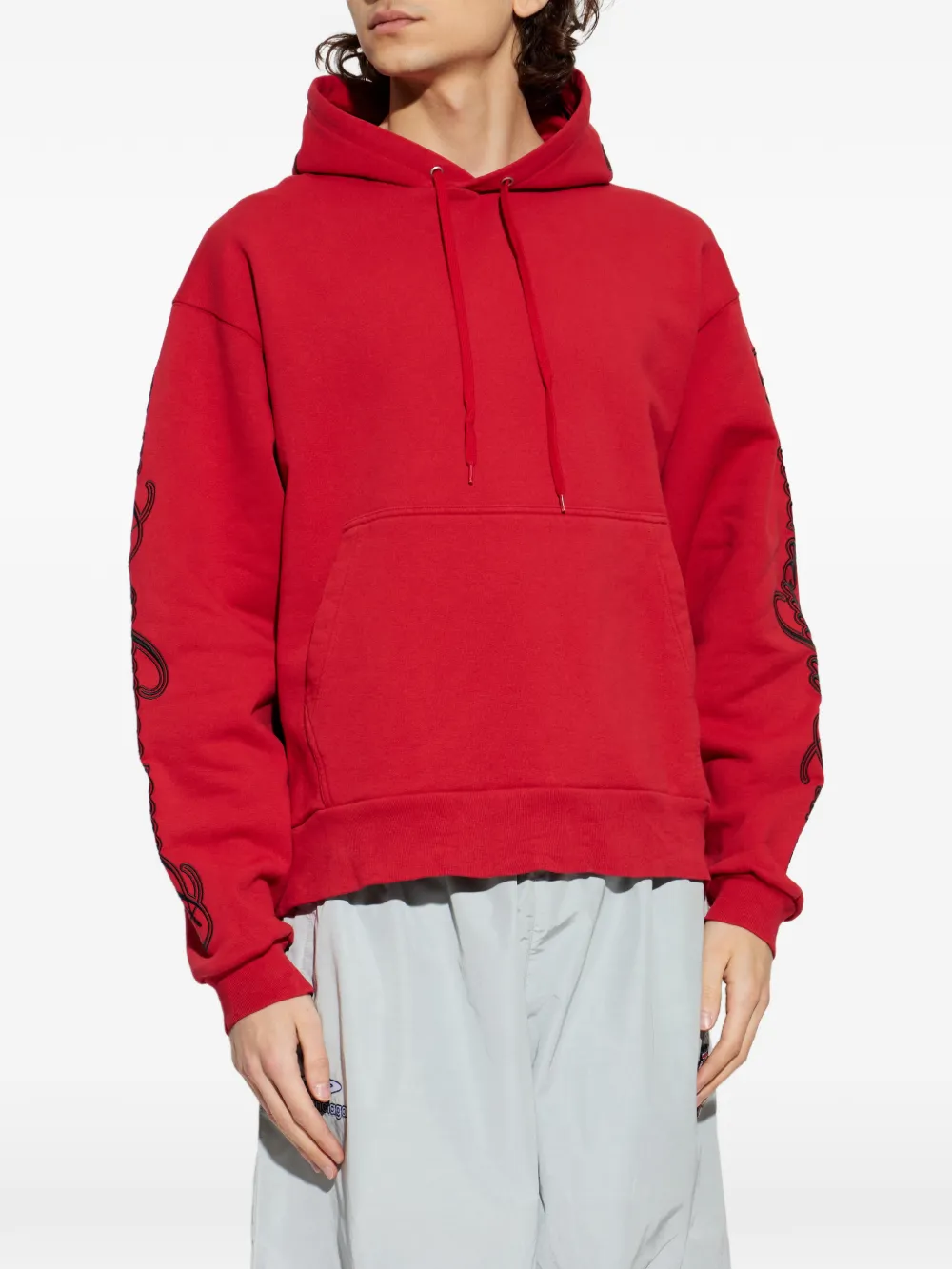 Red sweats-hoodies worn by a person, showing the cotton fit