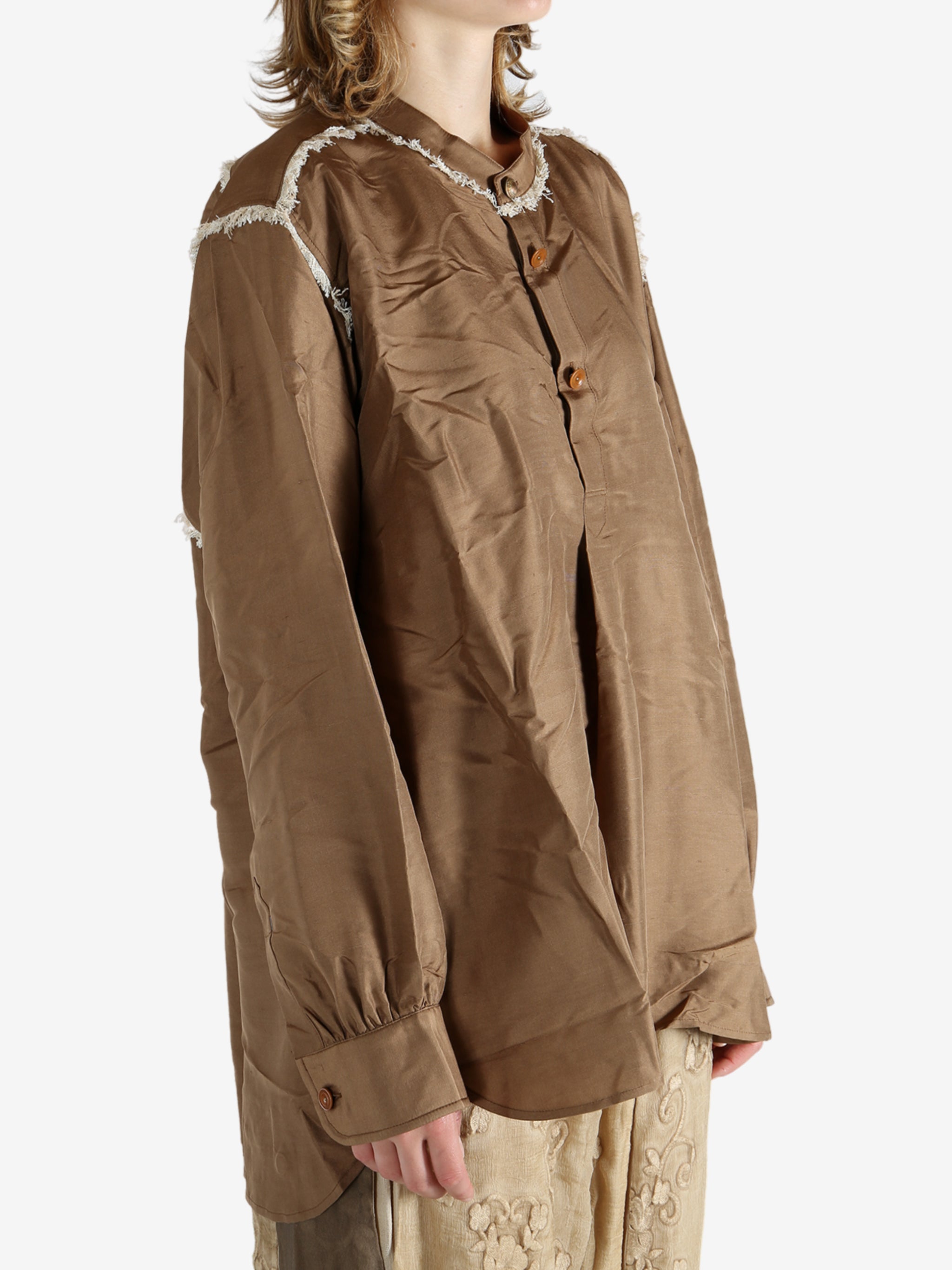 Brown shirt worn by a person, showing the shirt's fit