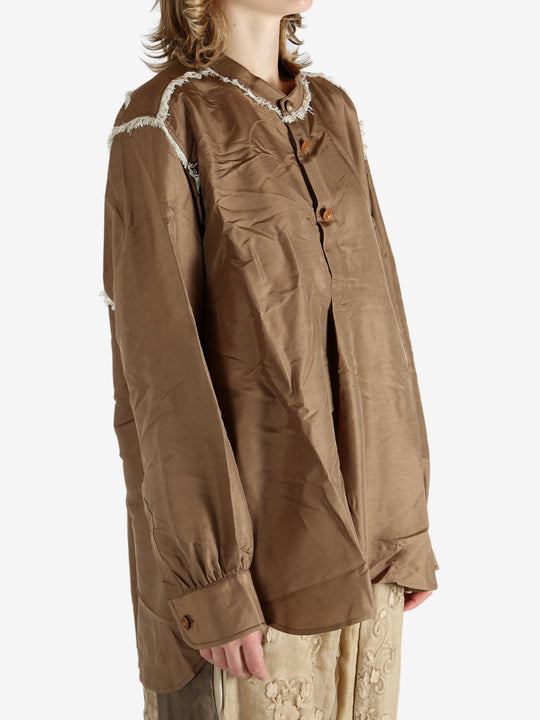 Brown shirt worn by a person, showing the shirt's fit