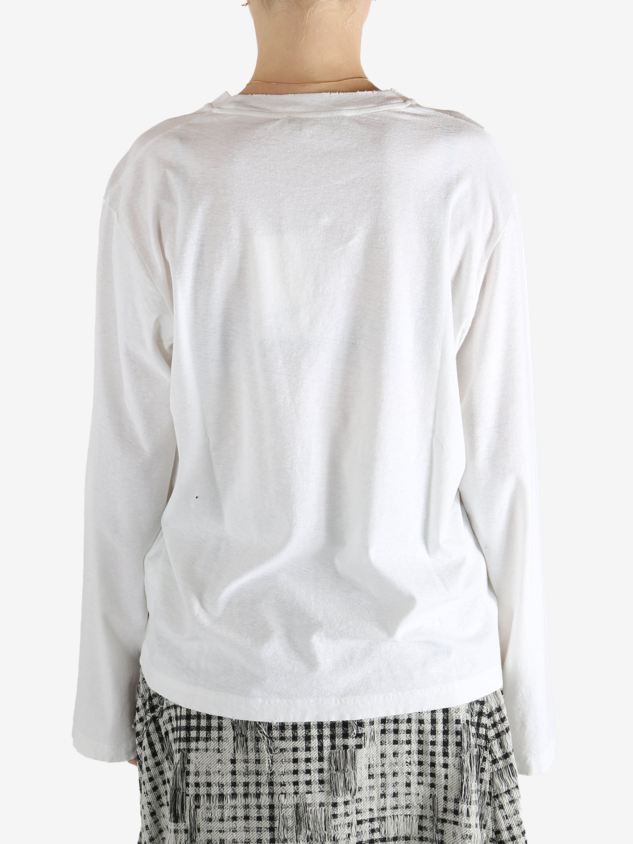 White t-shirt worn by a person, showing the t-shirt fit