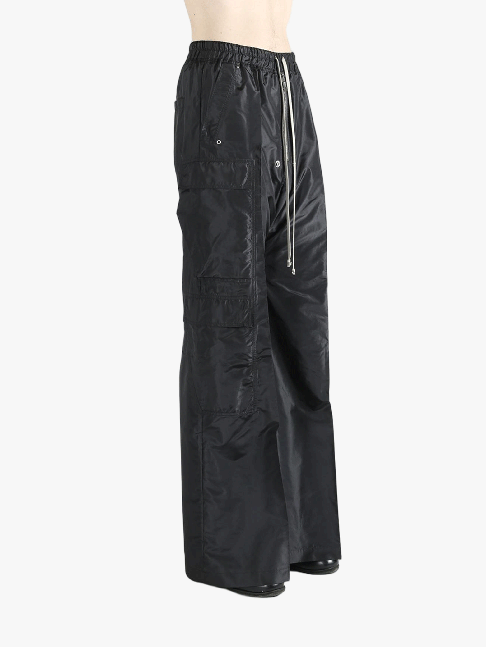 Black pants worn by a person, showing the pants's fit