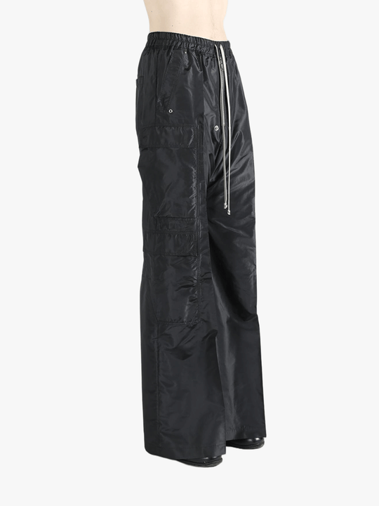 Black pants worn by a person, showing the pants's fit