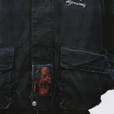 Close up of the black jacket, showing texture of the cotton fabric