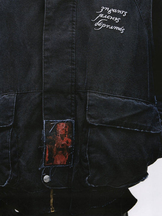 Close up of the black jacket, showing texture of the cotton fabric