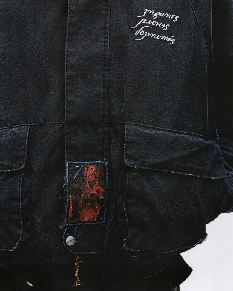 Close up of the black jacket, showing texture of the cotton fabric