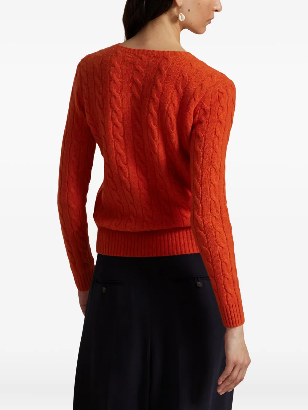 Orange knitwear worn by a person, showing the knitwear's fit