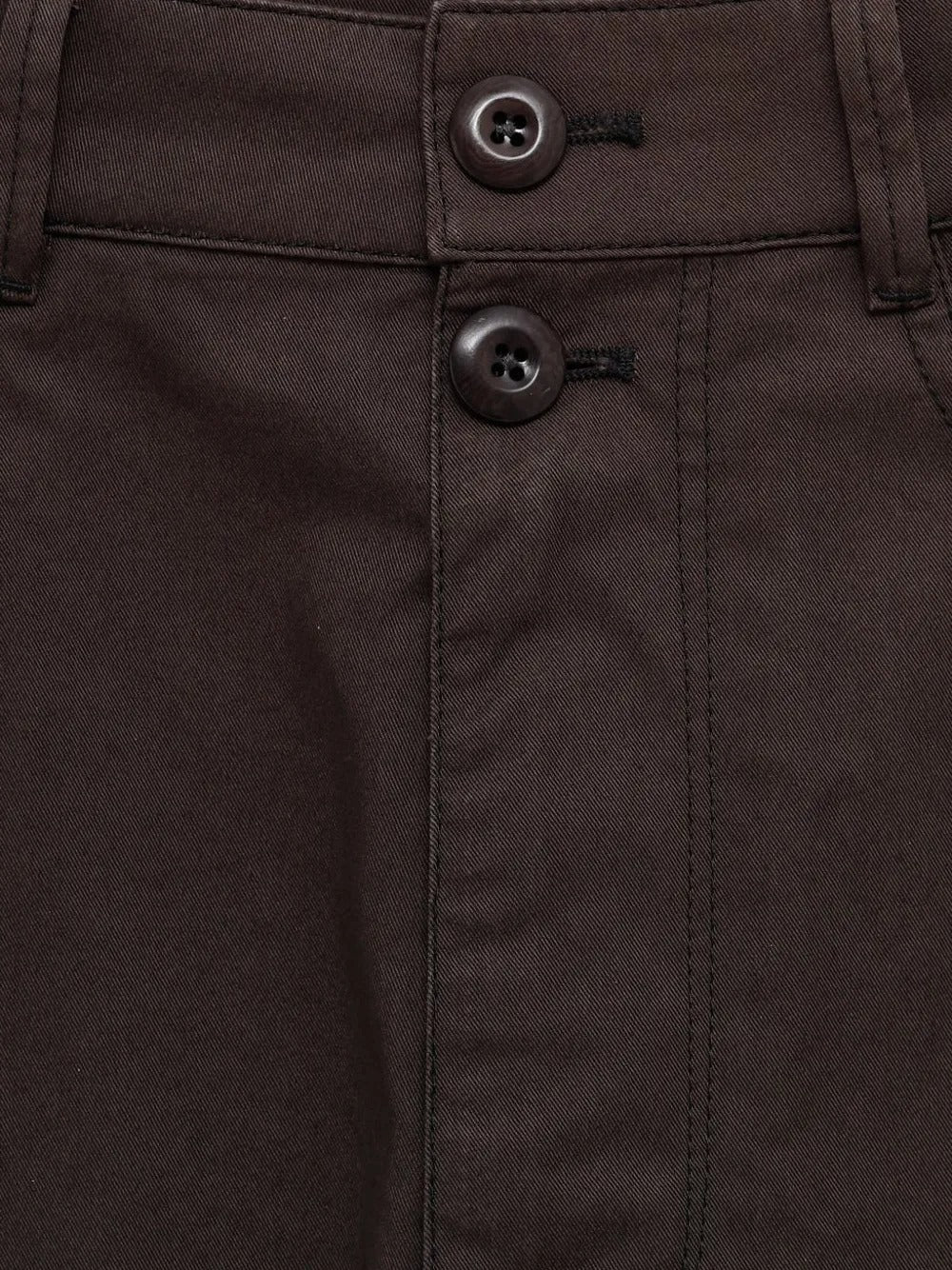 Close up of brown shorts, showing texture of the cotton fabric