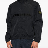Black jacket worn by a person, showing the jacket fit