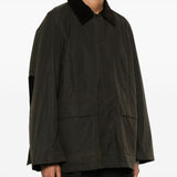 Green jacket worn by a person, showing the jacket’s fit