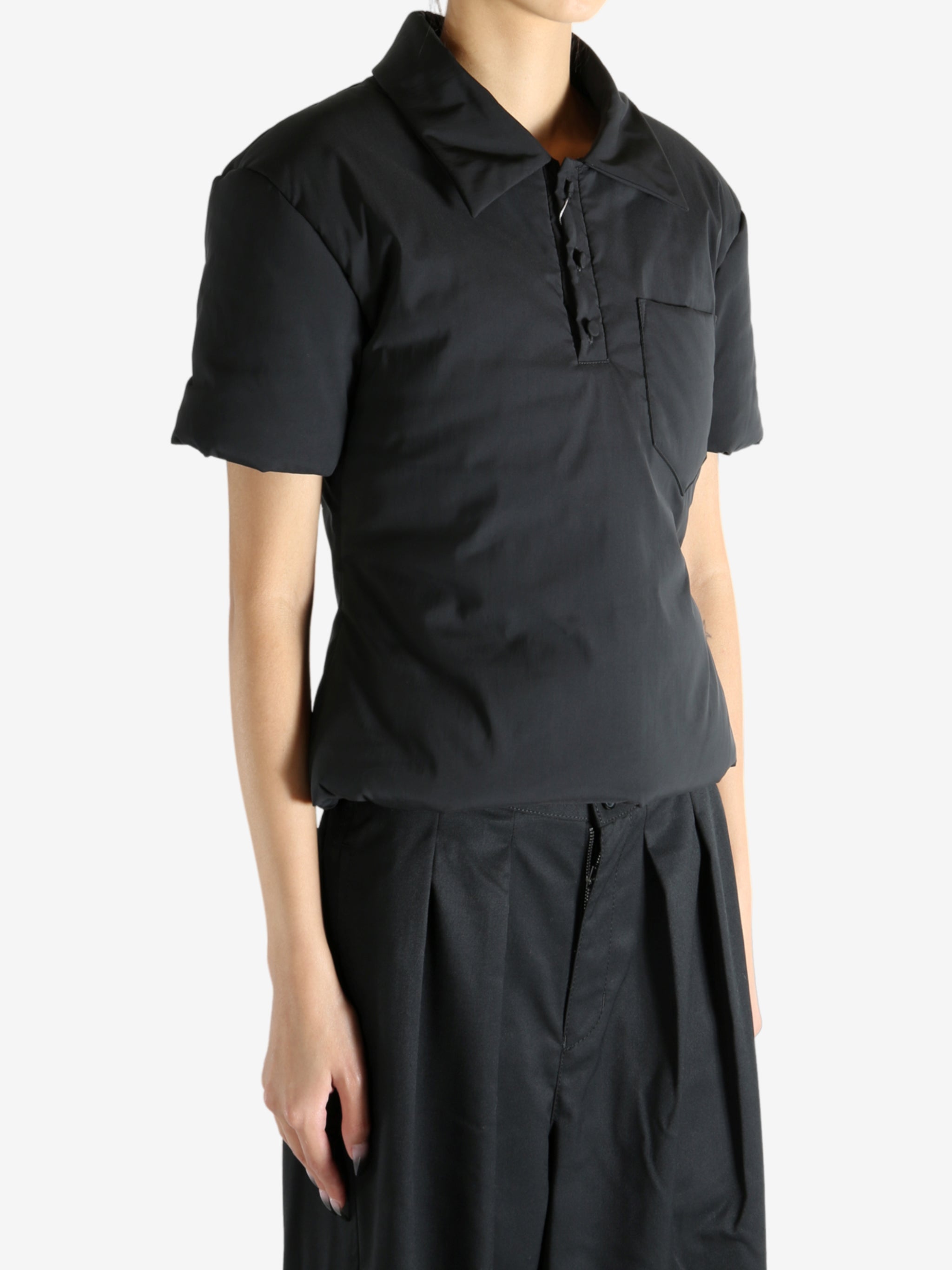 Black t-shirt worn by a person, showing the t-shirt's fit