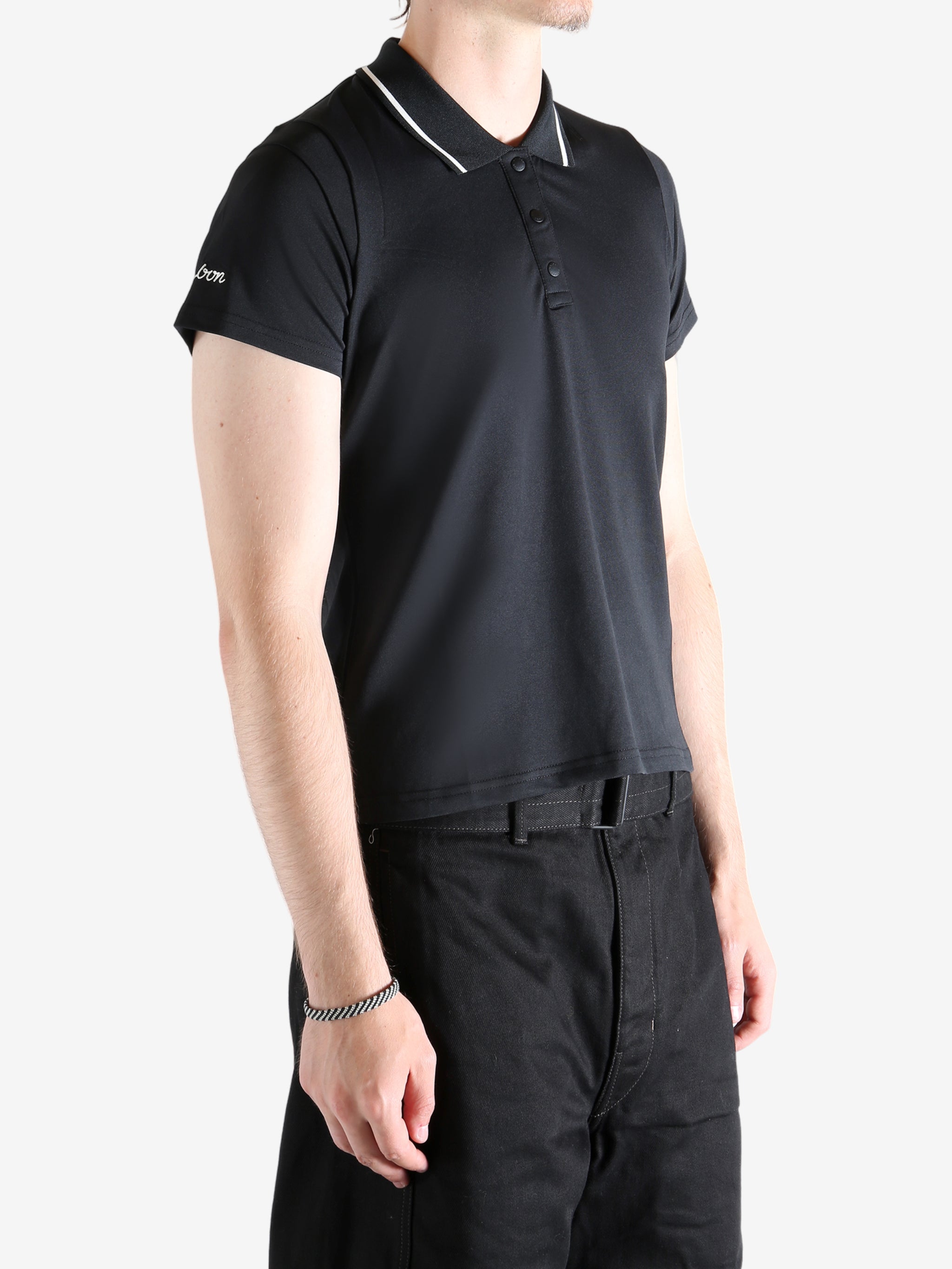 black shirts worn by a person, showing the shirts fit