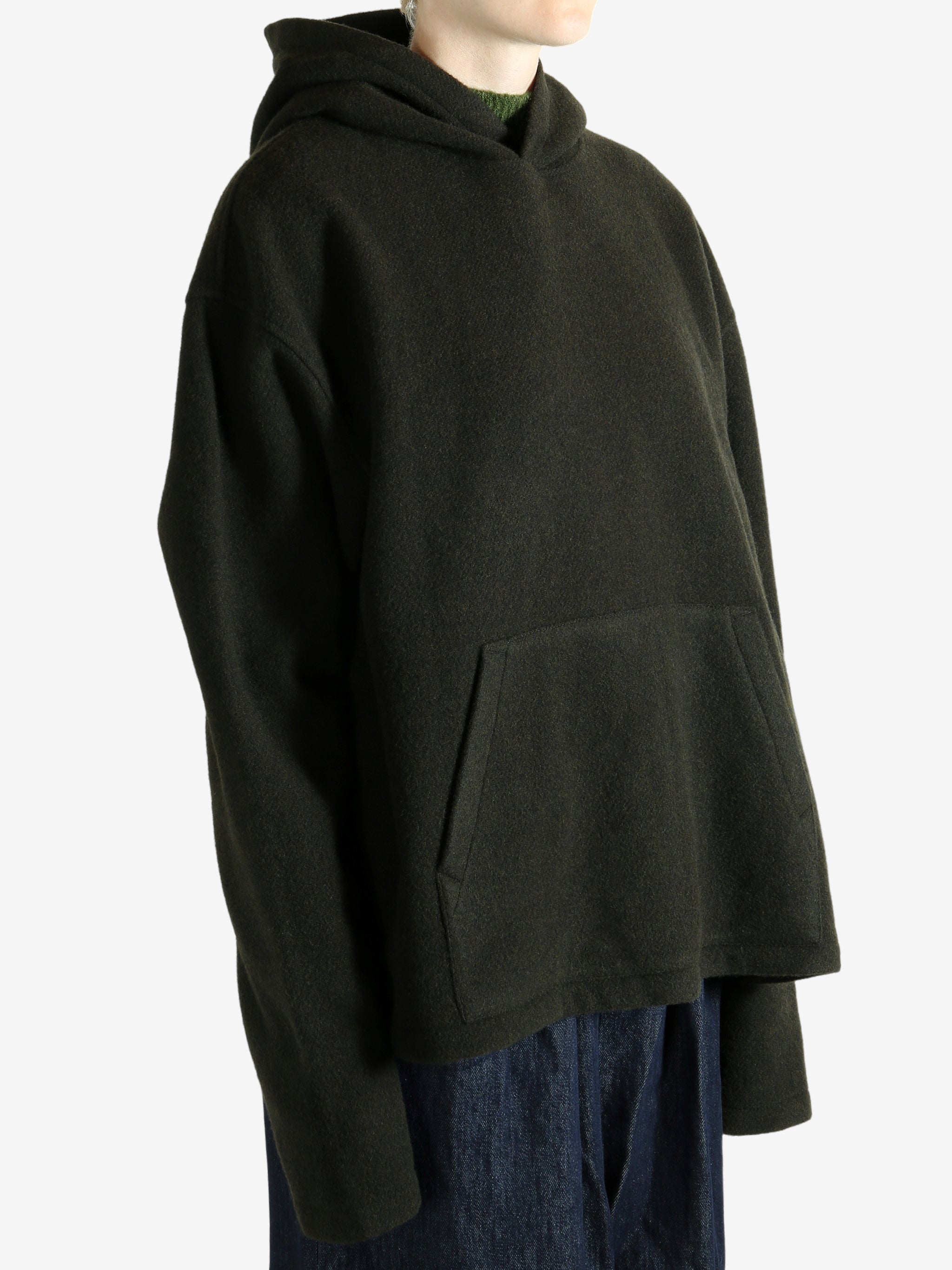 Green hoodie worn by a person, showing the hoodie's fit