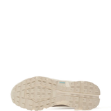 Close up of tan sneakers, showing texture of the rubber fabric