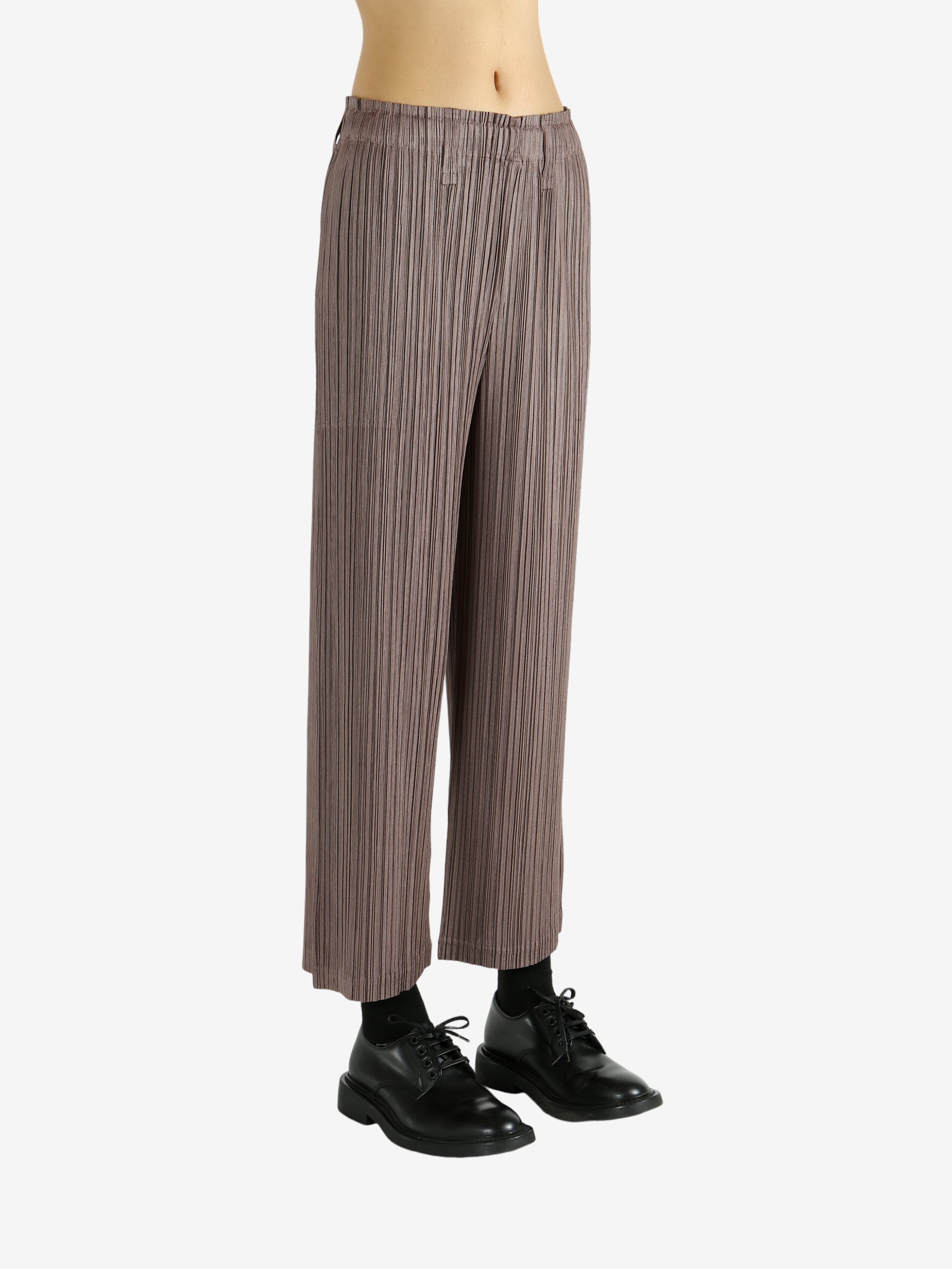 Brown pants worn by a person, showing the pants' fit