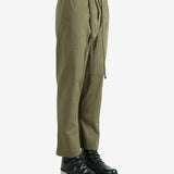 Green pants worn by a person, showing the pants's fit