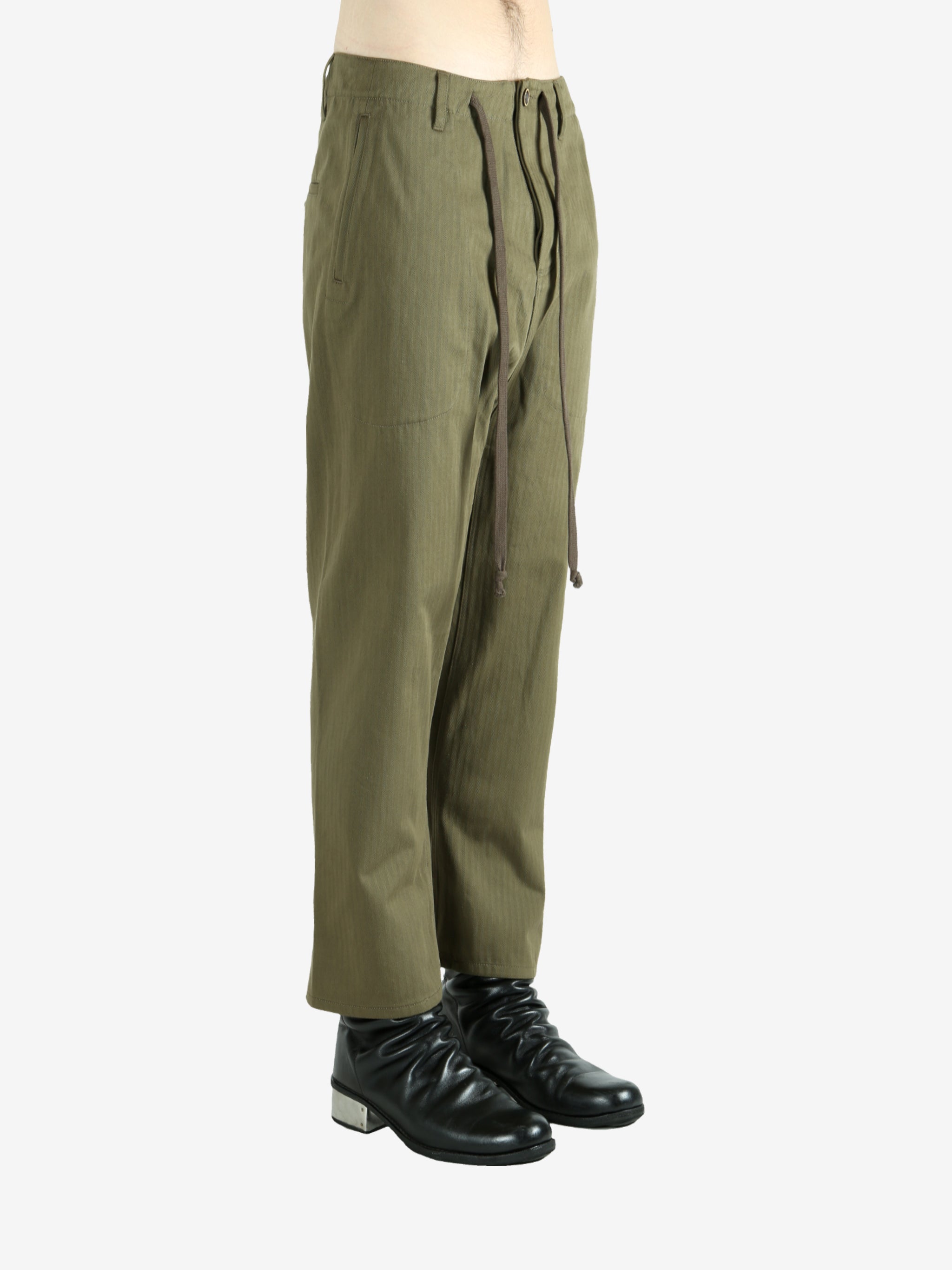 Green pants worn by a person, showing the pants's fit