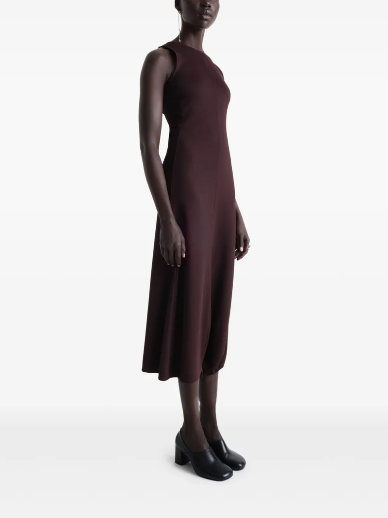 Burgundy dress worn by a person, showing the dress’ fit