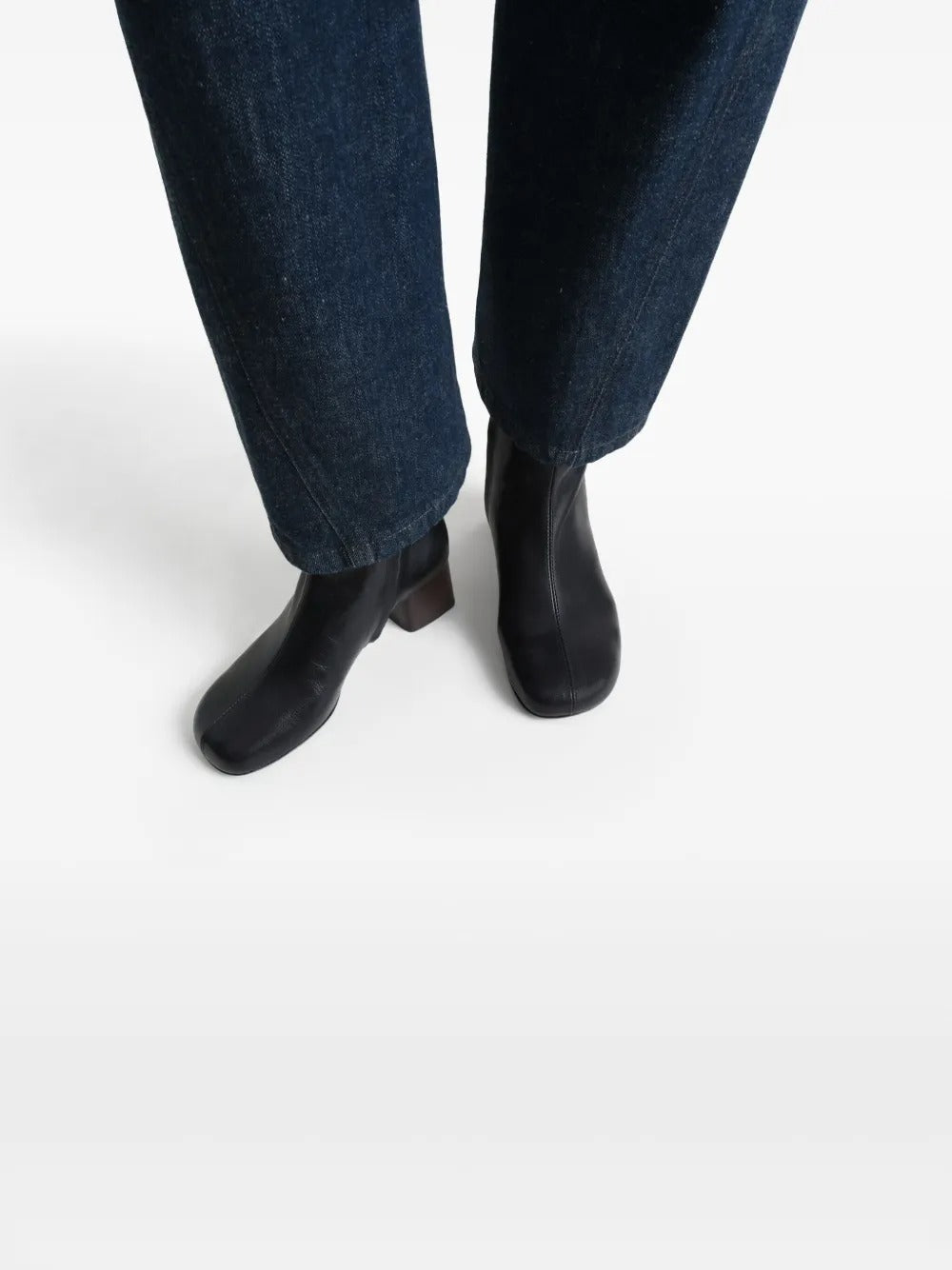 Black boots worn by a person, showing the boots' fit