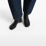 Black boots worn by a person, showing the boots' fit