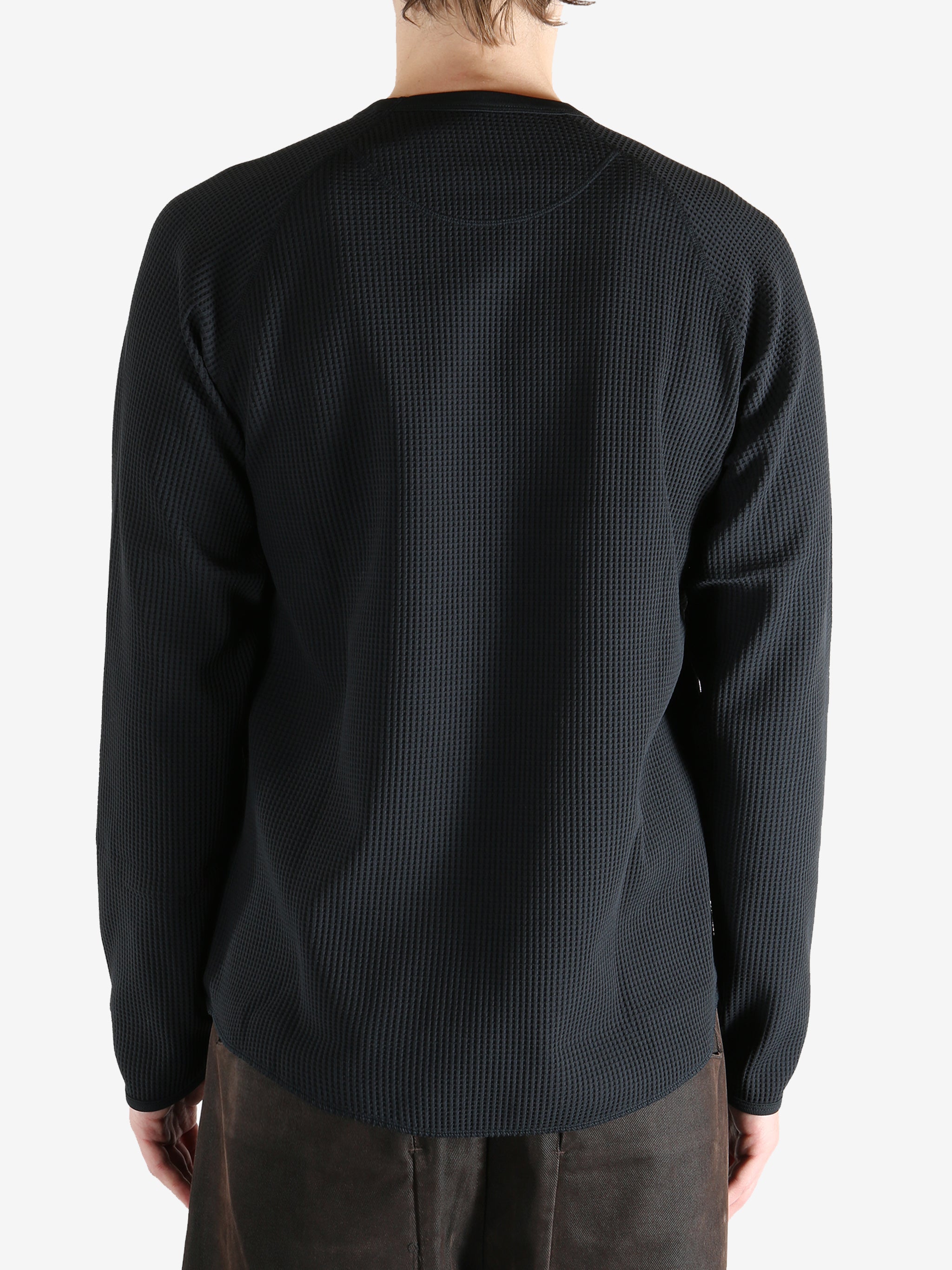 Black shirts worn by a person, showing the shirts fit