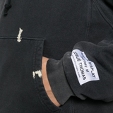 Close up of black hoodie, showing texture of the cotton fabric