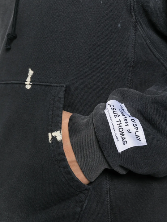 Close up of black hoodie, showing texture of the cotton fabric