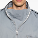Close up of grey windbreaker, showing texture of the Cotton fabric