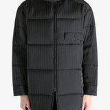 Black coat worn by a person, showing the coat's fit