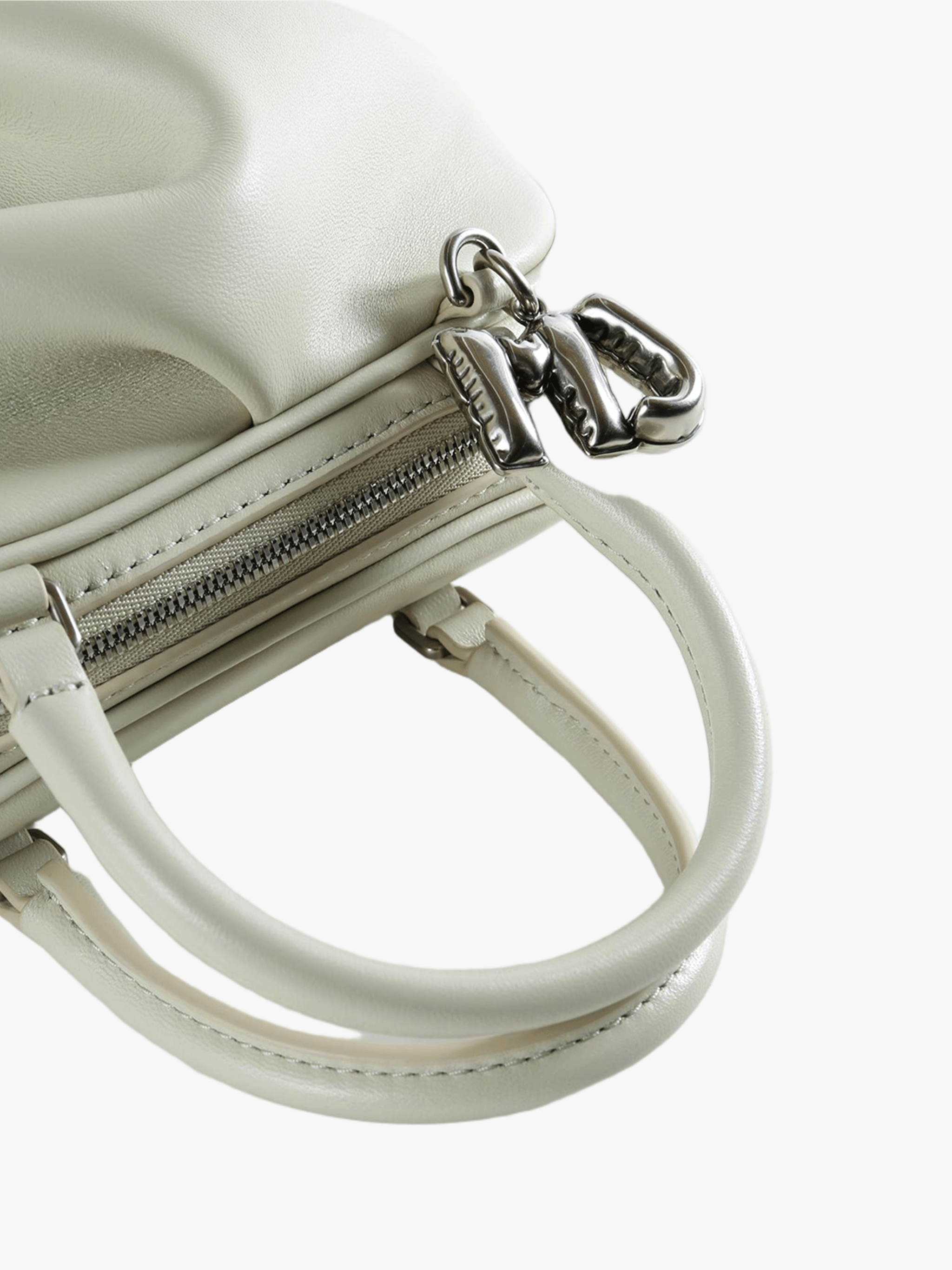 Close-up of tan bag, showing texture of the leather fabric