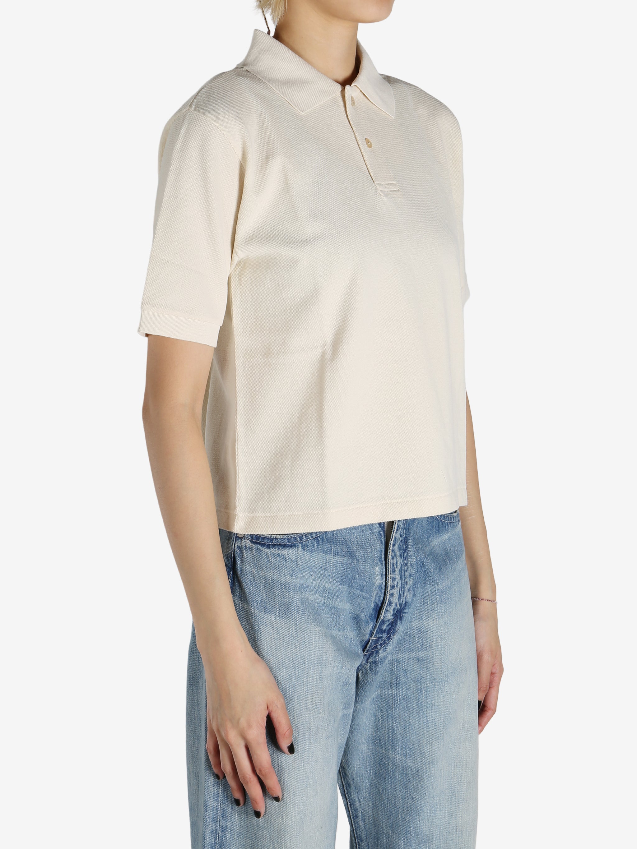 White shirt worn by a person, showing the shirt's fit