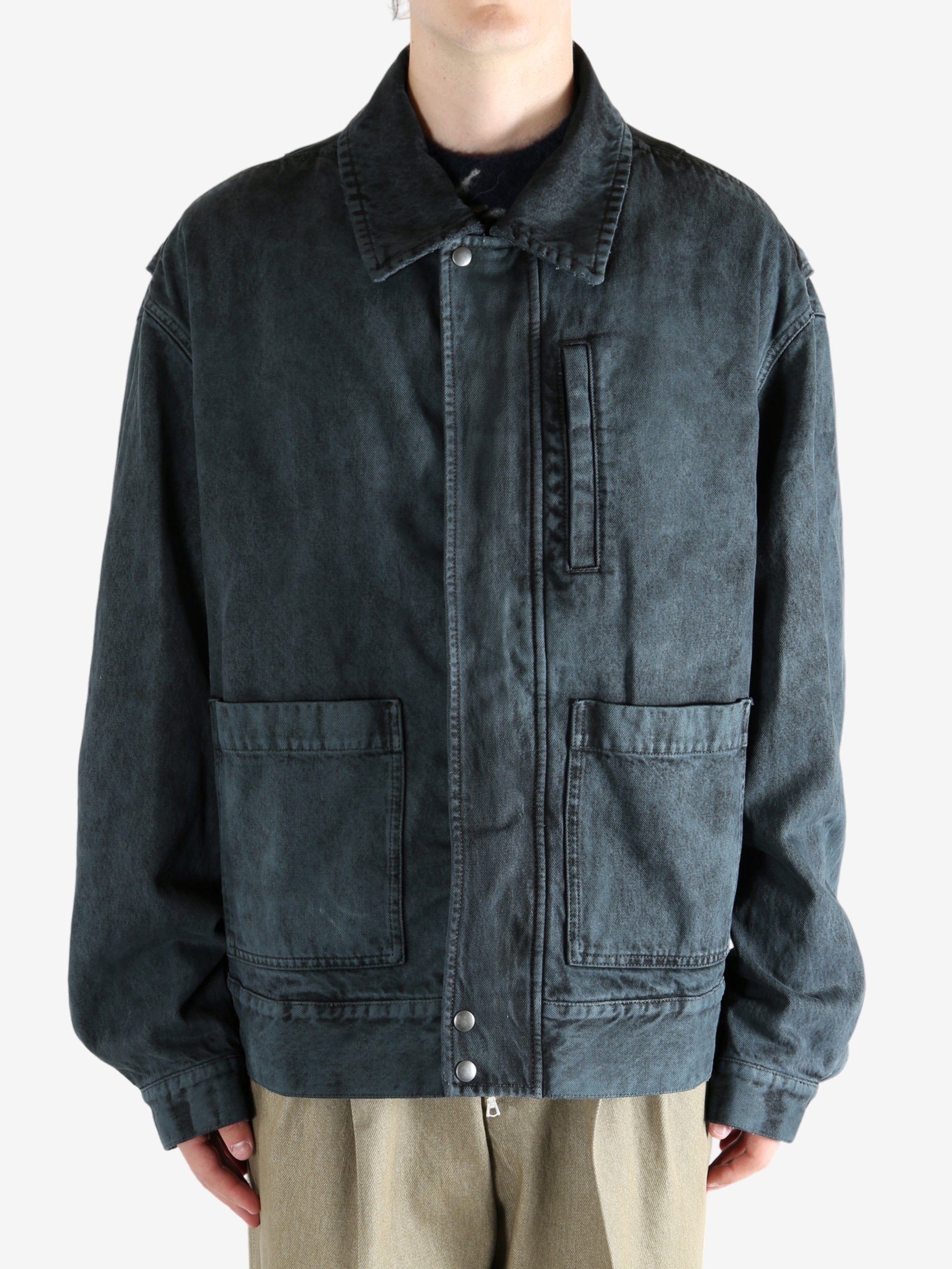 Blue jacket worn by a person, showing the jacket's fit