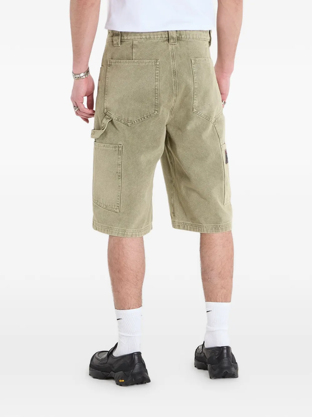 Green shorts worn by a person, showing the shorts fit