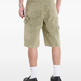 Green shorts worn by a person, showing the shorts fit