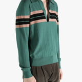 Green knitwear worn by a person, showing the knitwear's fit