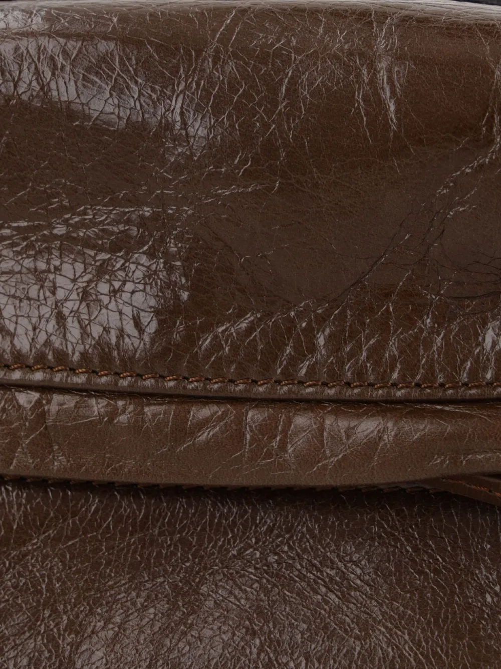 Close up of the brown bag, showing texture of the calfskin fabric