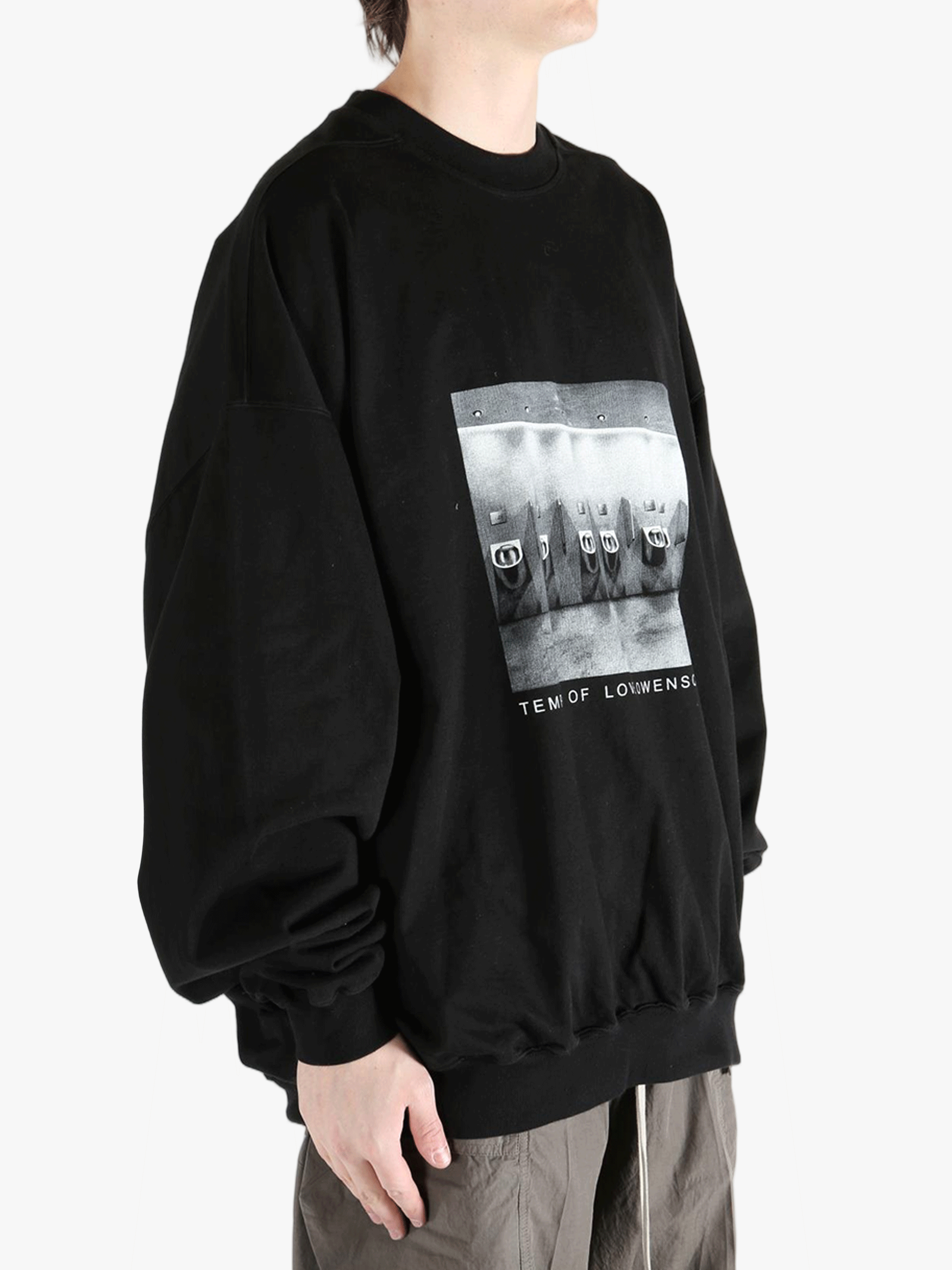 black t-shirts  worn by a person, showing the t-shirts fit