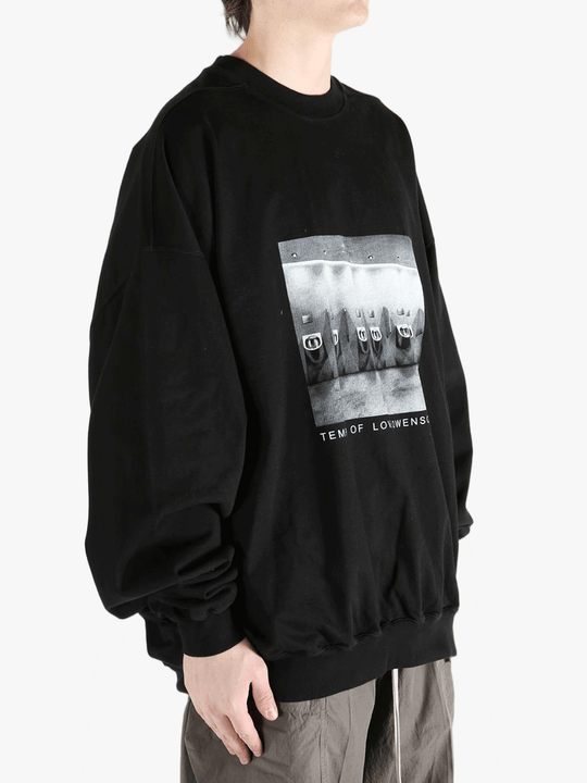 black t-shirts  worn by a person, showing the t-shirts fit