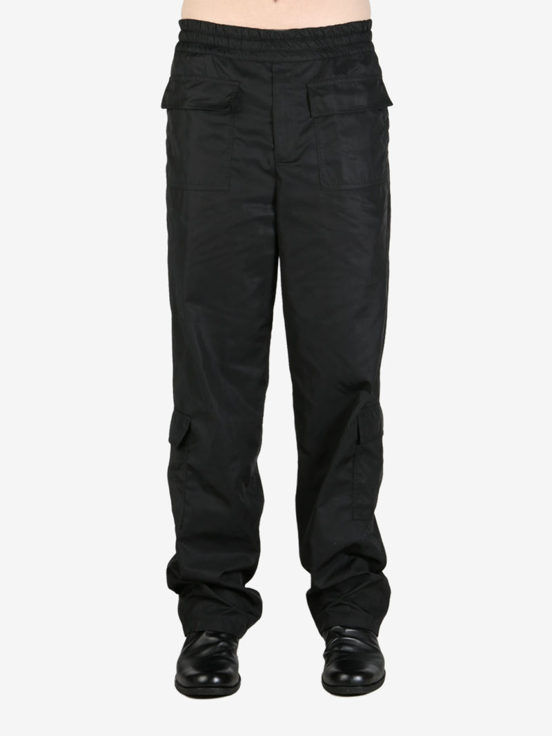 Black pendeen pants worn by a person, showing the pants's fit