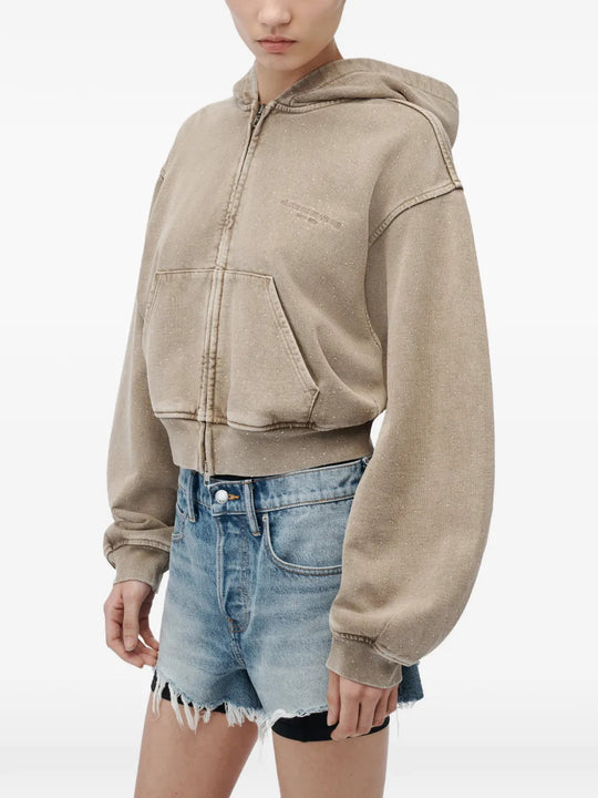 Tan hoodie worn by a person, showing the hoodie fit