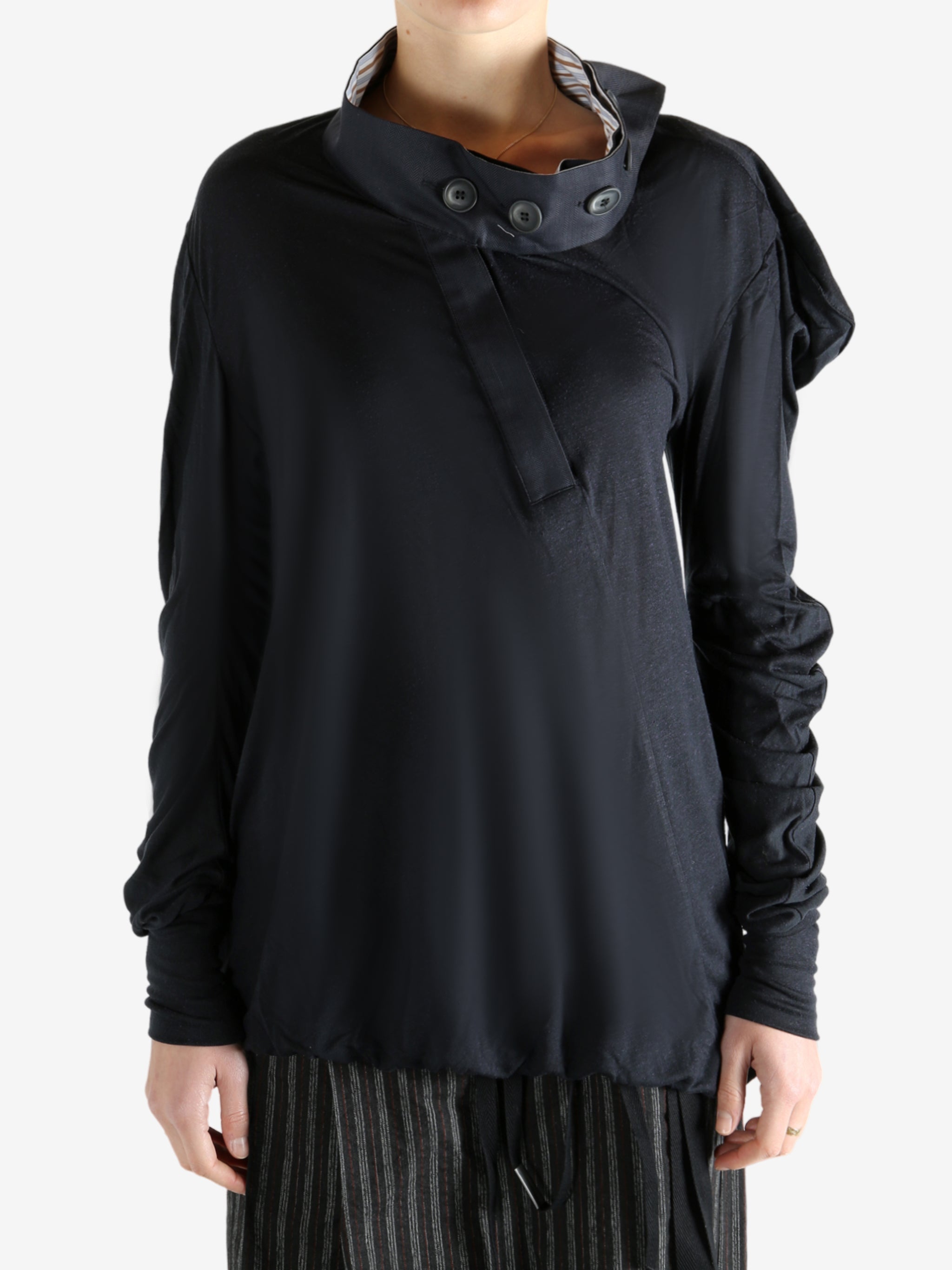 Black top worn by a person, showing the top's fit