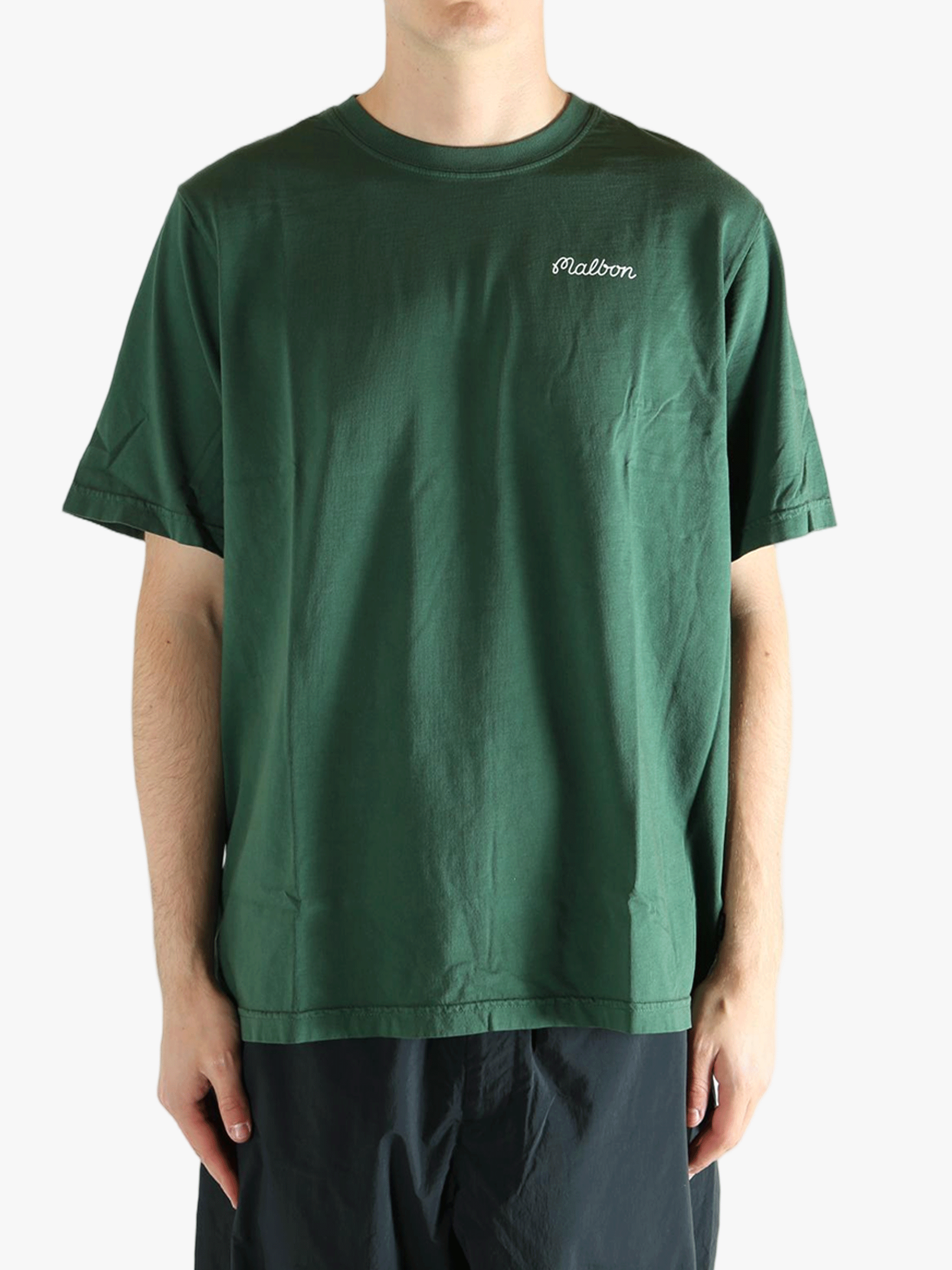 Green t-shirt worn by a person, showing the t-shirt fit