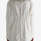 White shirt worn by a person, showing the shirt's fit