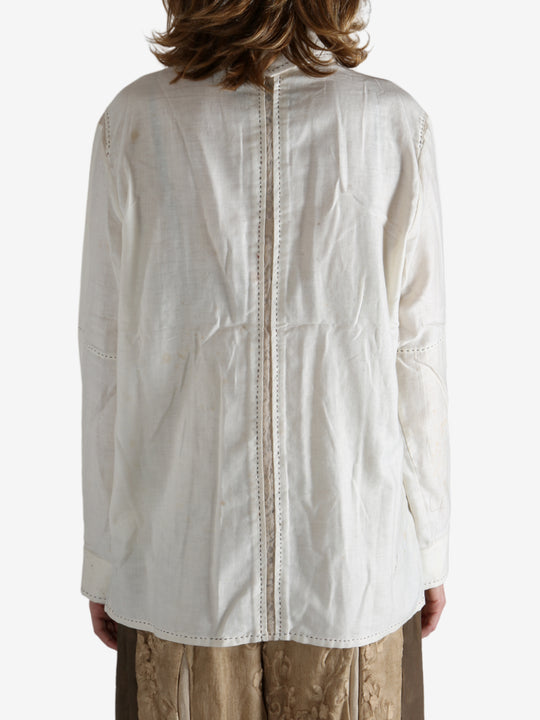 White shirt worn by a person, showing the shirt's fit