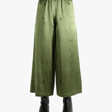 Green pants worn by a person, showing the pants fit