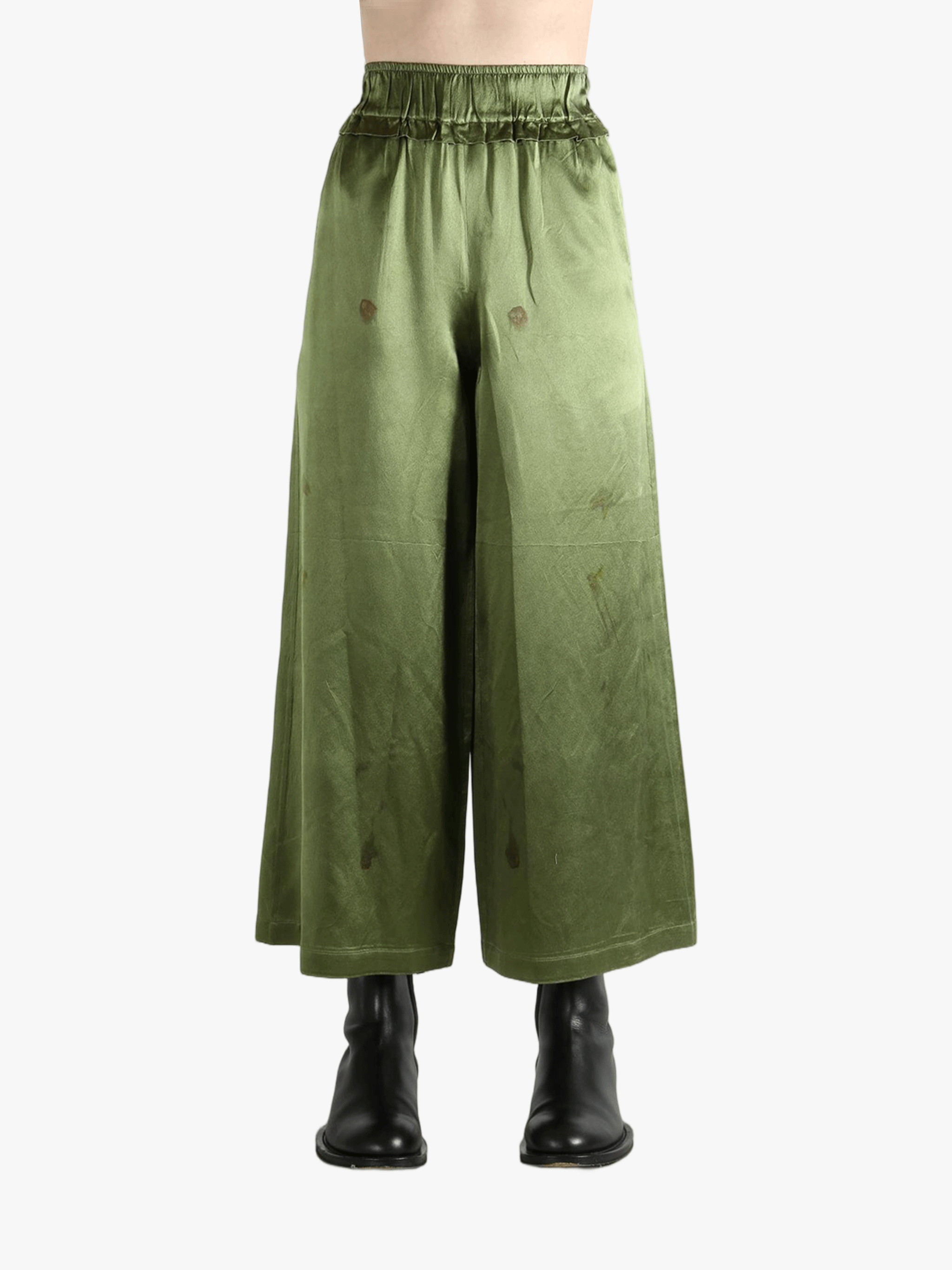 Green pants worn by a person, showing the pants fit