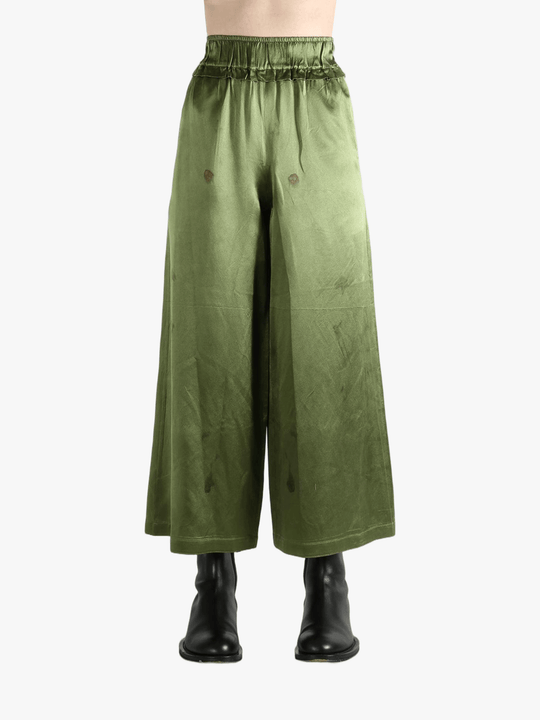 Green pants worn by a person, showing the pants fit