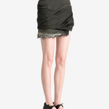 Green skirt worn by a person, showing the skirt fit